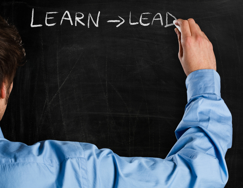 Man writing on a blackboard