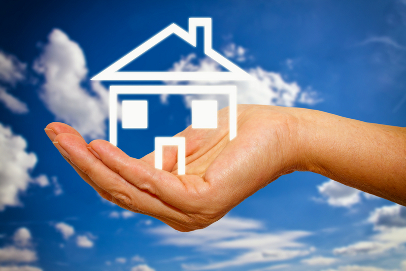 Woman’s hand holding a house icon